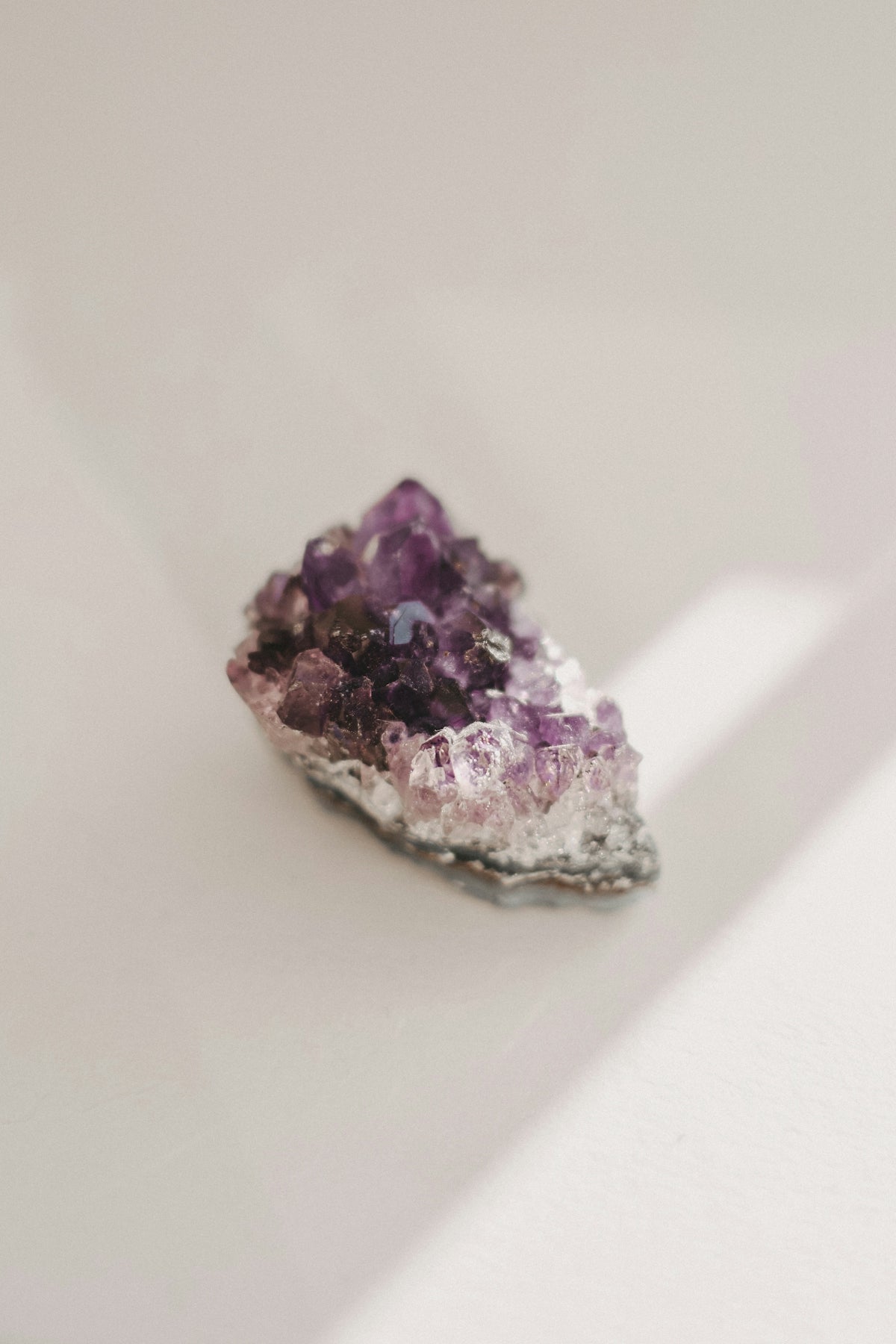 a cluster of purple crystals sitting on top of a white table