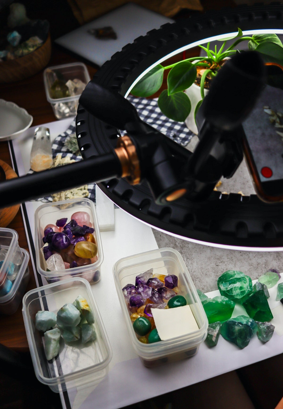 Colorful polished stones and crystals under a ring light